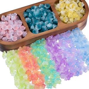Detailed macro view of colorful lily-of-the-valley glass flower beads for DIY jewelry making