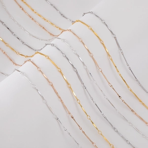 Detailed macro view of minimalist copper link chains in gold, silver, and rose gold finishes