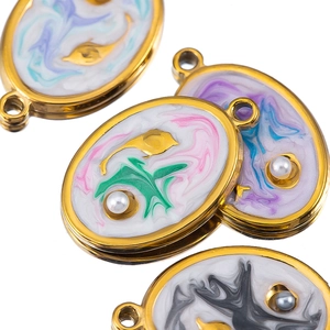 Detailed close-up of oval stainless steel marine pendant with enamel and pearl for DIY jewelry