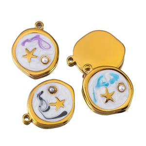 Detail of oval star charms with white enamel and colorful sand art for jewelry making