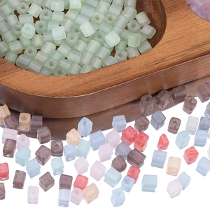 Macro view of 4mm matte macaron square beads with center holes on wooden tray