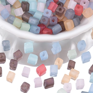 Macro shot of 4mm matte pastel cube beads with square holes for DIY jewelry making