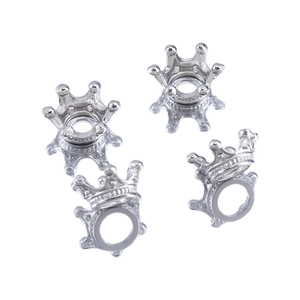 Macro detail of silver crown charms showing hollow base for pearl or bead setting