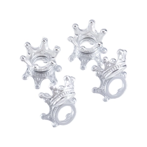 Detail of four polished silver crown charms for DIY jewelry making and handmade necklaces