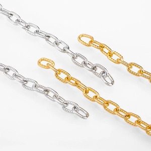 Macro detail of gold and silver textured aluminum oval link chains for DIY jewelry making