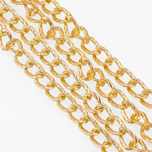 Macro shot of gold twisted oval chain links for DIY jewelry making and bag accessories