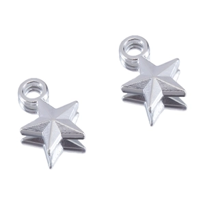 Macro shot of silver brushed metal star charms for DIY jewelry with clear reflections