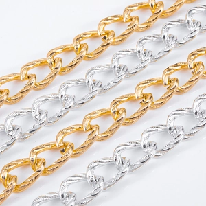 Close-up detail of textured aluminum twisted chains in gold and silver for DIY jewelry.