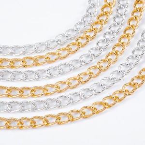 Close-up of gold and silver textured O-link chains with diamond-cut metal surface