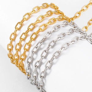 Detailed macro view of cross-embossed aluminum chain links in gold and silver finish