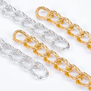 Detailed macro of gold and silver aluminum twist chains with spiral textured surface