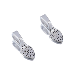 Macro shot of silver metal jewelry glue-on bail connectors with hole texture for DIY crafting