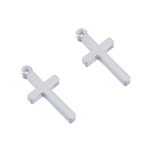 Close-up of polished silver cross pendants with top rings for DIY jewelry making
