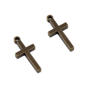 Macro detail of retro bronze alloy cross charms for DIY jewelry and necklace making