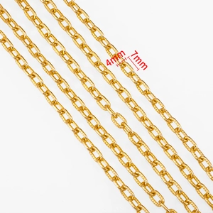 Macro detail of golden 4x7mm cross-embossed aluminum chain links for DIY jewelry making