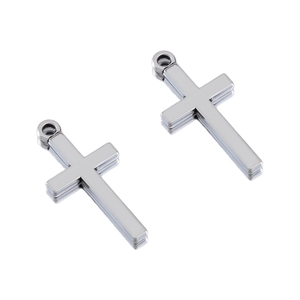 Detail of two vintage silver polished cross charms with hanging rings for DIY jewelry