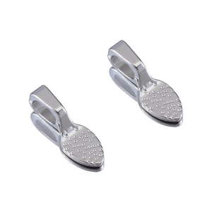 Macro shot of silver alloy leaf charms with embossed texture and polished metal finish