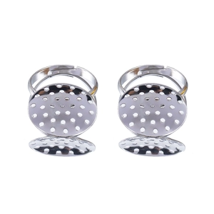 Close-up of adjustable silver metal ring base with porous oval tray for DIY jewelry