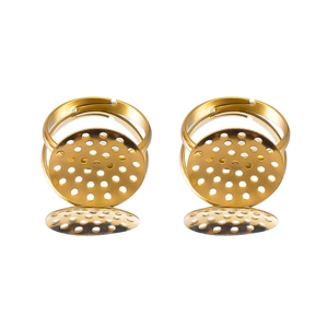 Close-up of golden adjustable ring bases with perforated round trays for DIY jewelry making