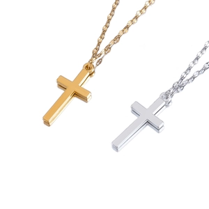 Polished gold and silver cross pendants on flat metal chains over white background
