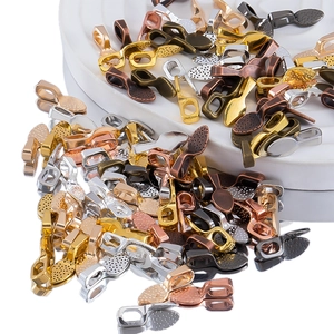 Macro detail of alloy jewelry bail connectors in various metallic finishes and textures