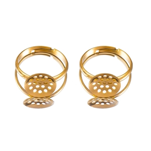 Close-up of golden adjustable ring bases with round perforated trays for DIY jewelry making