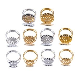 Detailed view of adjustable gold and silver ring bases with perforated round trays
