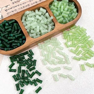 Detail of bamboo joint glass beads in green gradients for DIY jewelry making