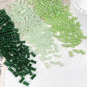 Detailed view of bamboo-shaped green glass beads for DIY handcrafted jewelry making