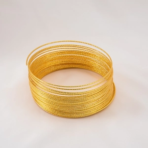Macro detail of multi-layer sparkling gold-plated wire coil bracelet for DIY jewelry
