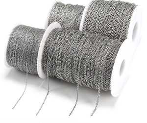 Macro view of four rolls of silver stainless steel cross chains for DIY jewelry making