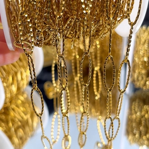 Close-up of golden embossed oval chain link roll for DIY jewelry making and crafting