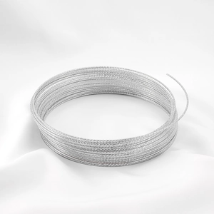 Close-up of sparkling silver textured wire coils for DIY jewelry making on silk