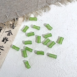 Macro detail of emerald green bamboo-shaped glass beads for Chinese style DIY jewelry