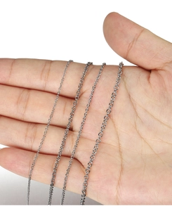 Comparison of four different thicknesses of stainless steel cable chains on a hand