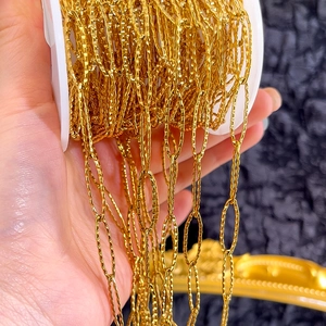 Detailed view of golden stainless steel chain roll with textured diamond-embossed oval links