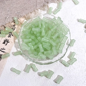 Macro shot of light green bamboo-shaped glass beads for DIY jewelry making