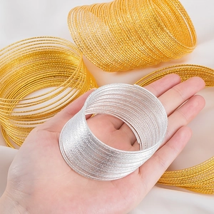 Multi-layer textured steel coil bracelet set in gold and silver with stardust finish