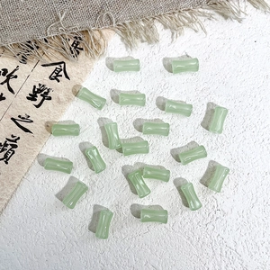 Macro shot of light green bamboo-shaped glass beads for DIY jewelry making