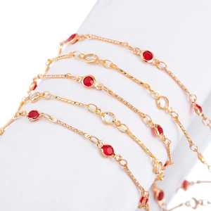 Detail of 4mm gold-plated chain with alternating red and clear crystals wrapped on white base