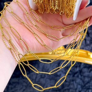 Macro detail of textured gold rhombus chain links for DIY jewelry making and necklaces