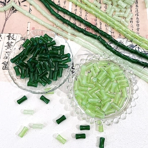 Detailed close-up of green bamboo-shaped glass beads for DIY jewelry making accessories
