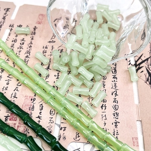 Macro shot of bamboo-shaped glass beads in light and dark green for jewelry DIY