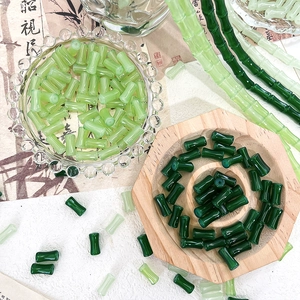 Detailed macro view of light and dark green glass bamboo tube beads for DIY jewelry