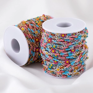 Colorful daisy seed bead chain for DIY bohemian jewelry on two white plastic spools