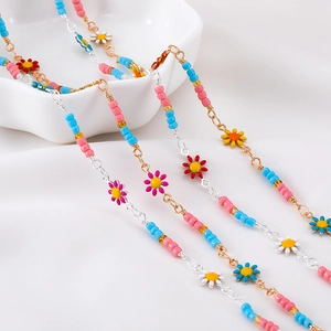 Detail of colorful daisy beaded chains featuring pink and blue summer floral pendants
