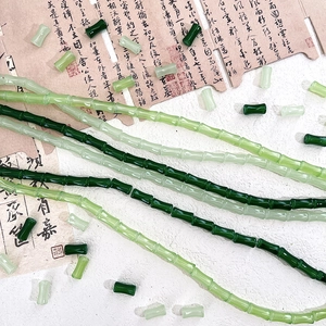 Detailed view of bamboo-shaped green glass beads for DIY handcrafted jewelry making