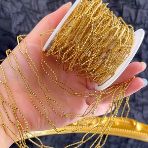 Detailed view of faceted gold stainless steel chain on spool for DIY jewelry making