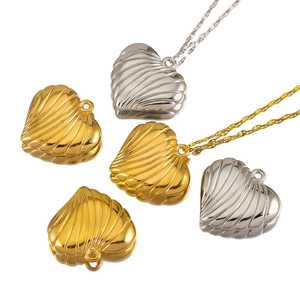 Macro detail of heart-shaped pendants with ribbed texture in gold and silver metal finish