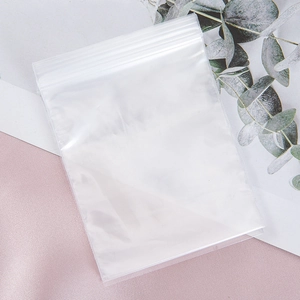 Detailed view of high-transparency PE plastic self-sealing bags on elegant fabric